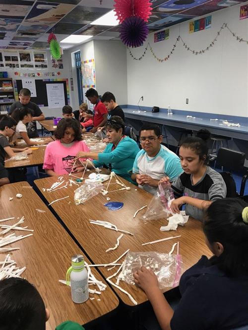 Students work together to build tall towers. Students work together to build tall towers.