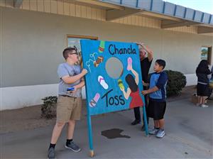 Parent volunteers, students, and staff set up for fall festival. 